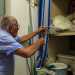 Uno scaffale celato da una tenda a strisce bianche e blu conserva le reti in cotone e nylon...